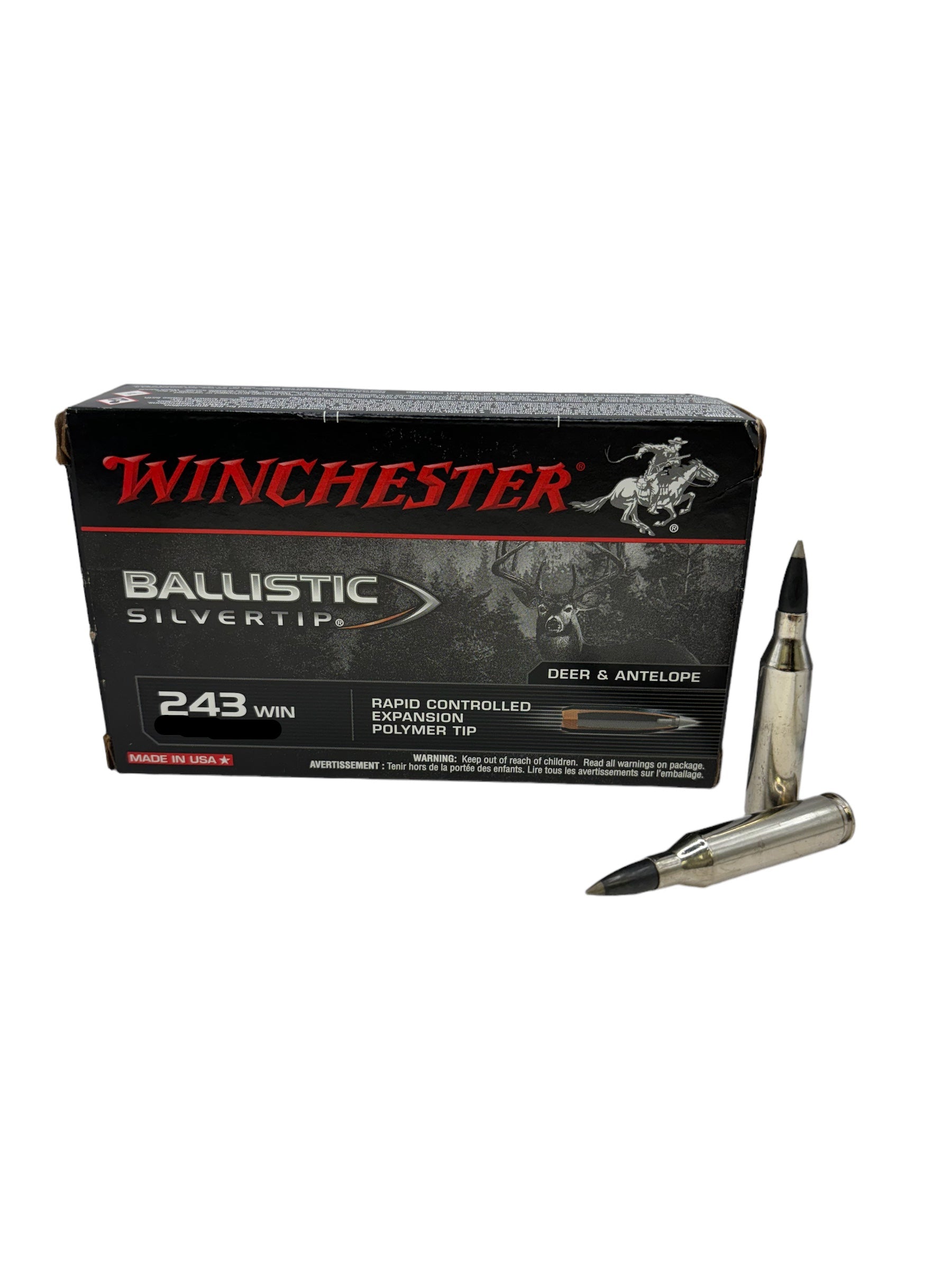 A box of Winchester Ballistic Silvertip .243 95GR Polymer Tip ammunition with a few rounds displayed in front of it.
